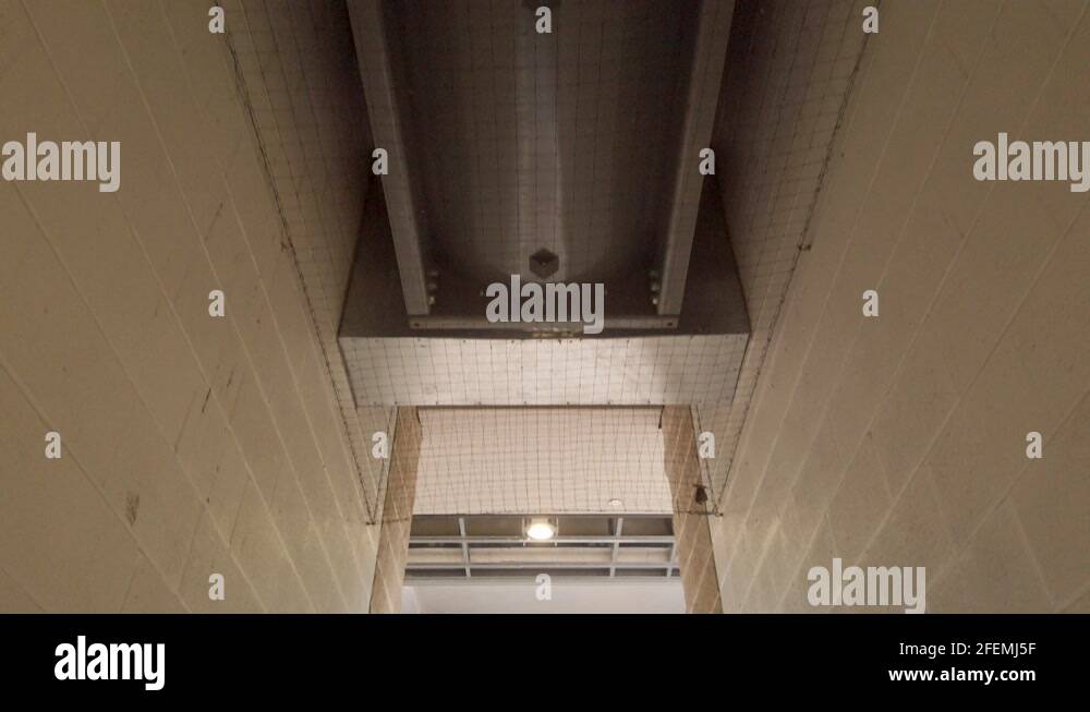 HVAC system in ceiling of hallway in underground parking garage in