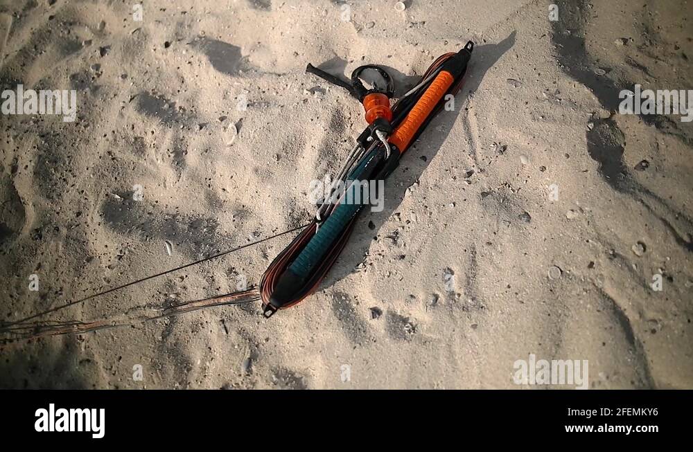 zoom in footage of kitesurfing bar and lines on the sand Stock Video