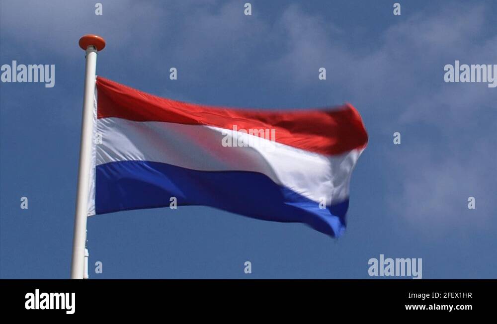 Dutch national flag in blue sky waving in wind Kingdom of The