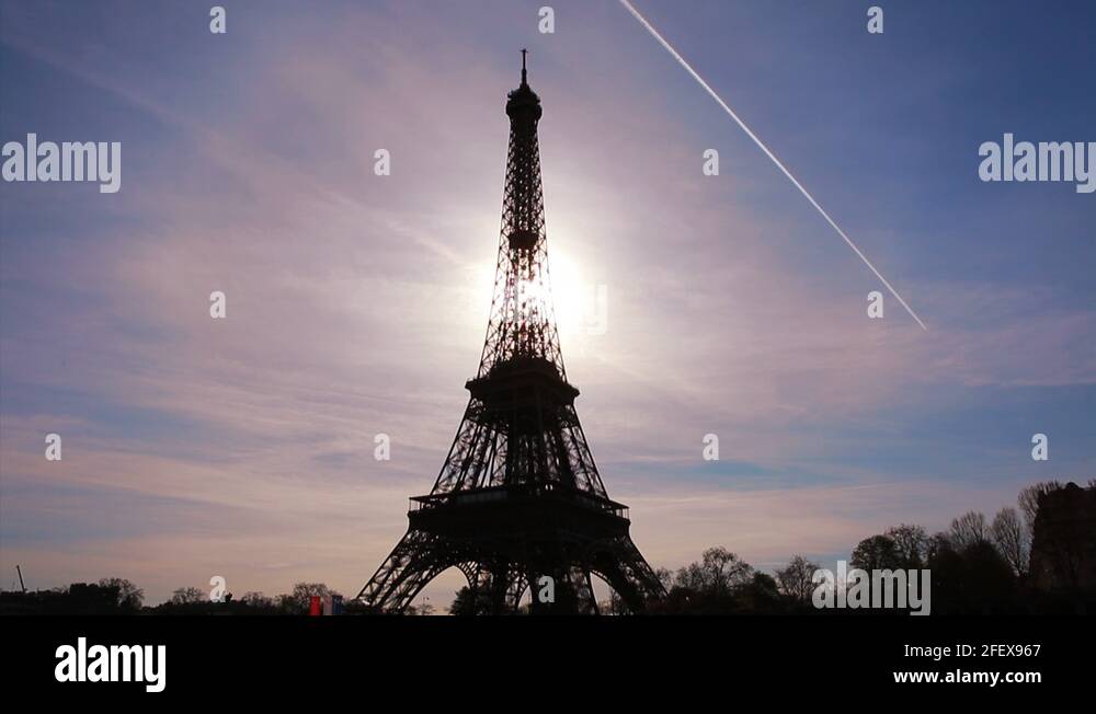 Eiffel Tower and rolling clouds. Sun setting time lapse. Paris, France