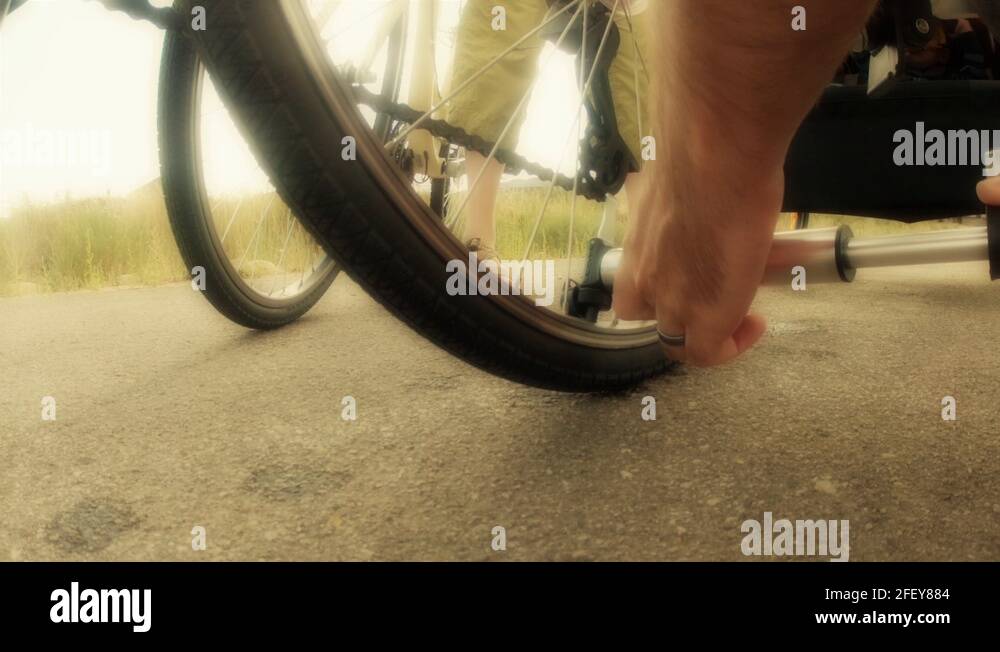 filling up flat tire on a bike ride Stock Video Footage Alamy