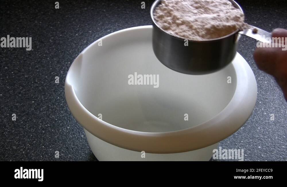 Measuring Cake Mix Into A Mixing Bowl With A Cup Measure Stock Video
