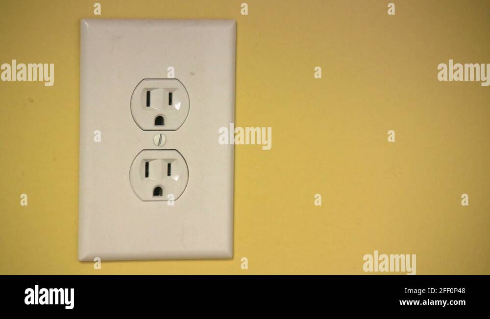 Plug unplug wall power electricity outlet cable wire prong hand insert