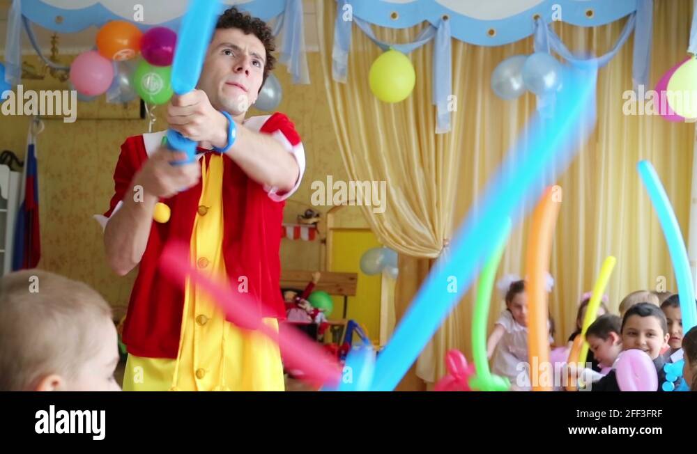 Pinocchio makes inflatable swords for children in kindergarten Stock ...