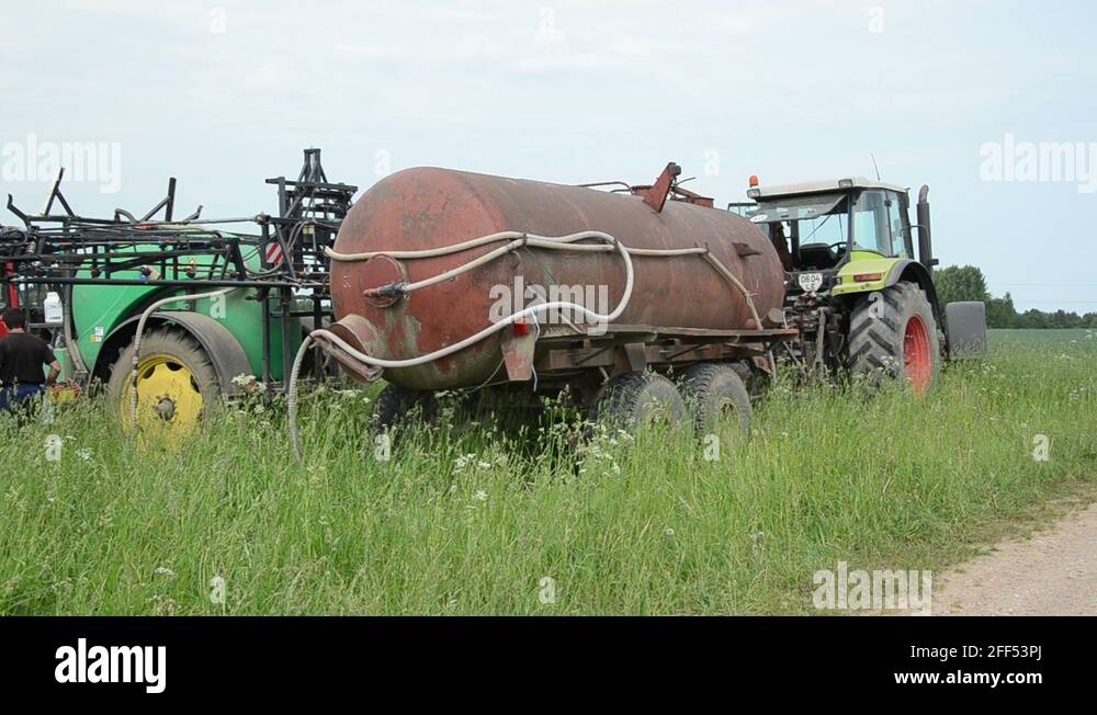 tank full of chemical pesticides sprayed on crops to young Stock Video