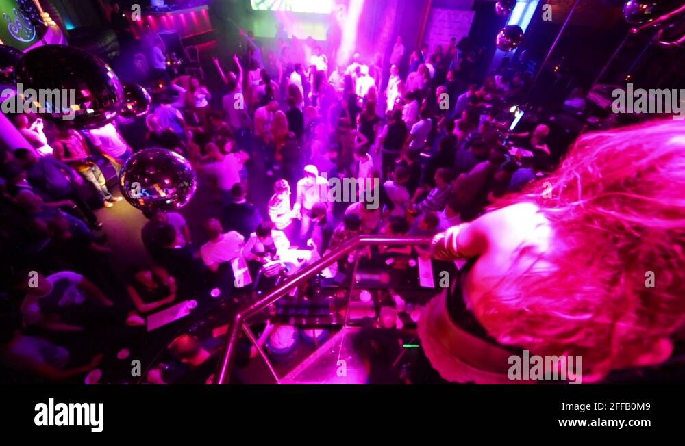 Gogo girl dance on balcony above bar counter in Stock Video