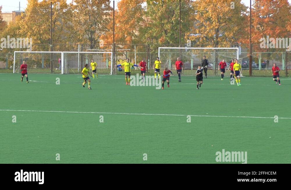 Unknowns athletes in red and yellow uniform are playing football Stock ...