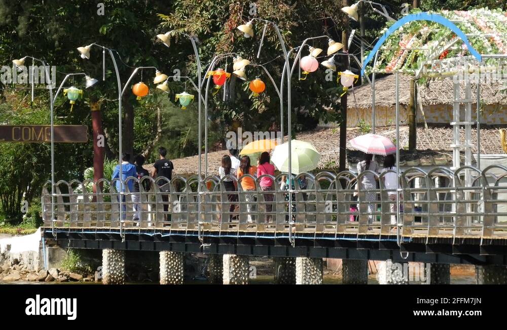 People walking with an umbrella at a bridge in Pathein, Myanmar, Burma