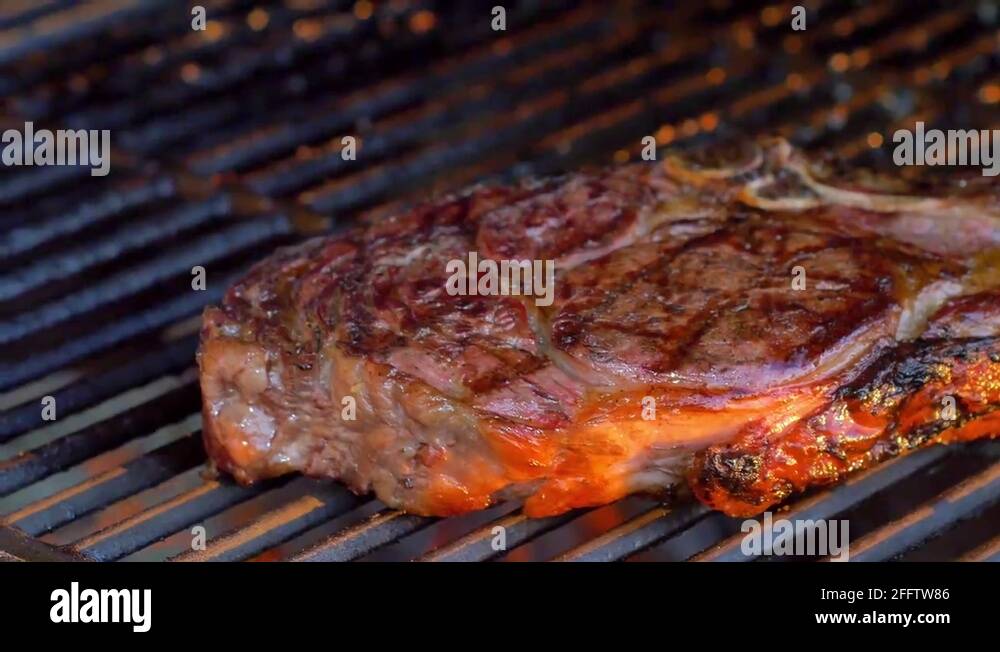Ribeye steak on charcoal grill, 4K Stock Video Footage Alamy