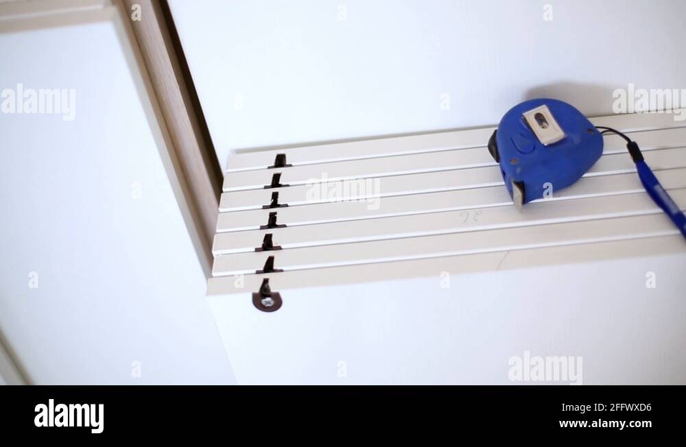 Stack of shelves for sliding door wardrobe with tapemeasure Stock