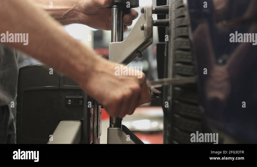 Car wheel fixed with computerized wheel alignment machine Stock Video ...