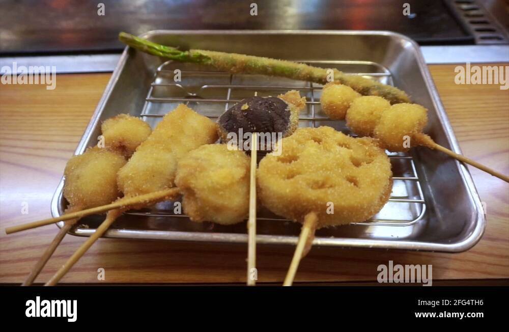 Kushikatsu, Osaka food Japanese dish of seasoned, skewered and deep fried meat Stock Video
