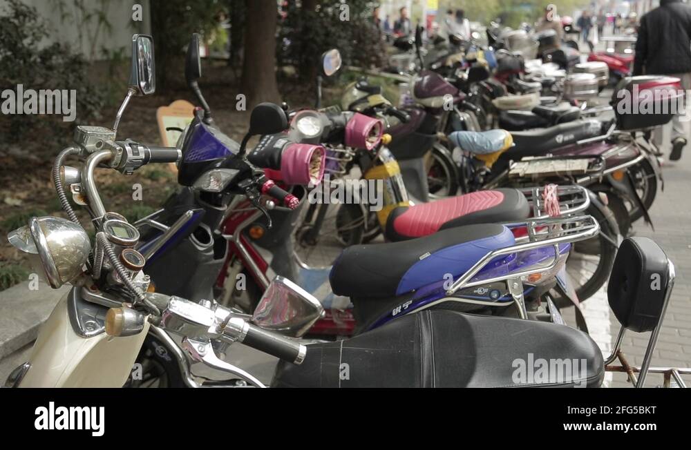 Mopeds parked on a busy street in Asia Stock Video Footage Alamy