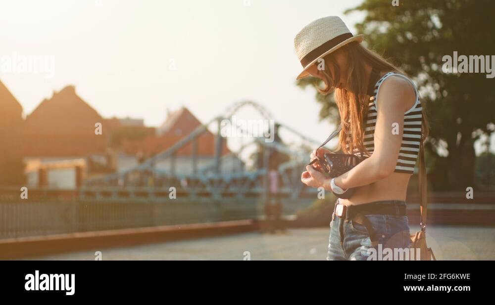 Tourist photographer changing a battery in the camera. Slow Motion