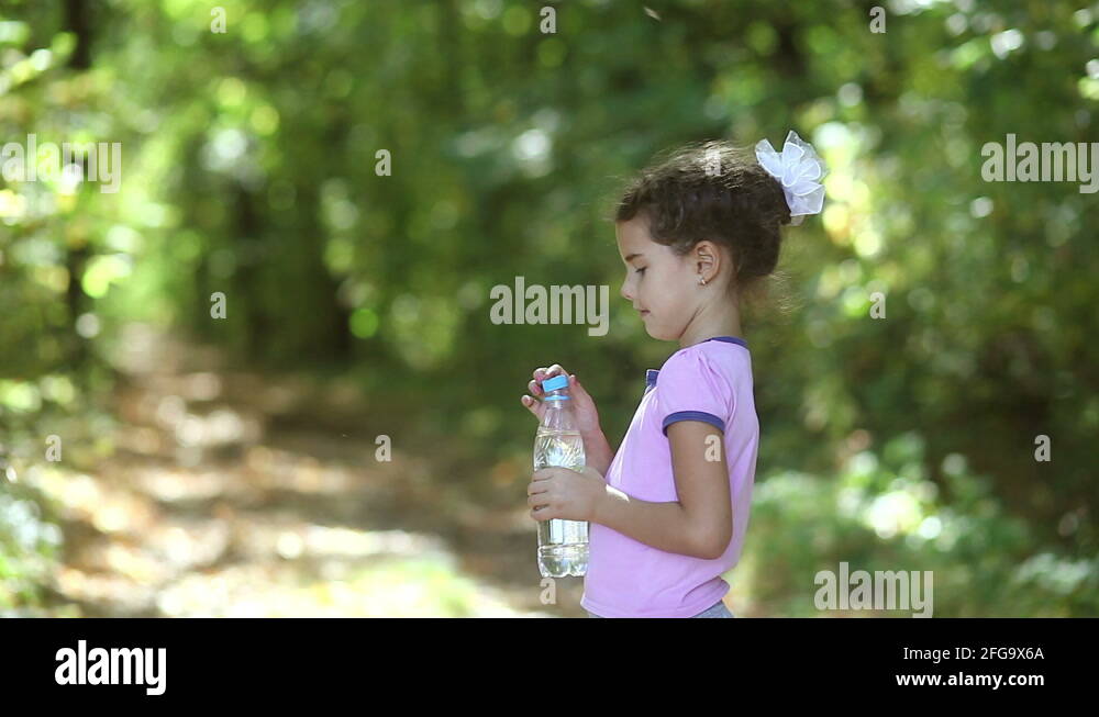 Healthy teen girl drinking water from th, Stock Video