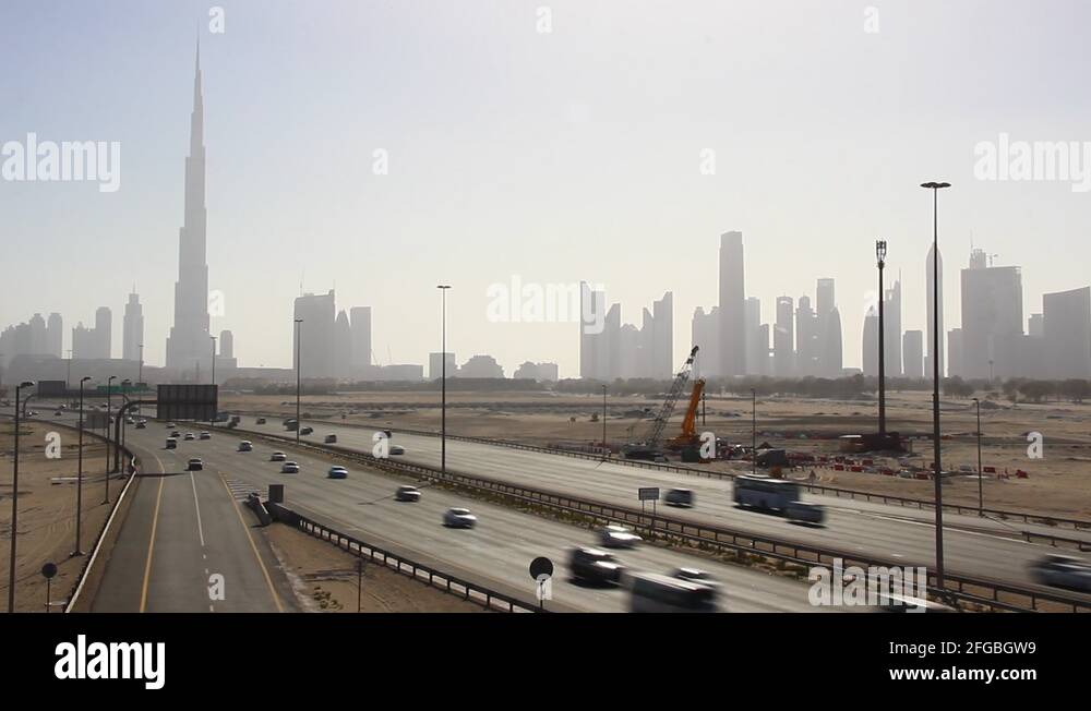 Dubai skyline from undeveloped desert side, skyscraper silhouettes in ...