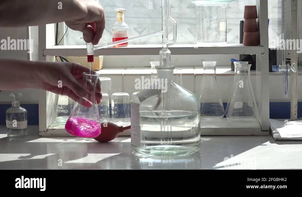 Acid titration in Erlenmeyer glass, laboratory method Stock Video Footage Alamy