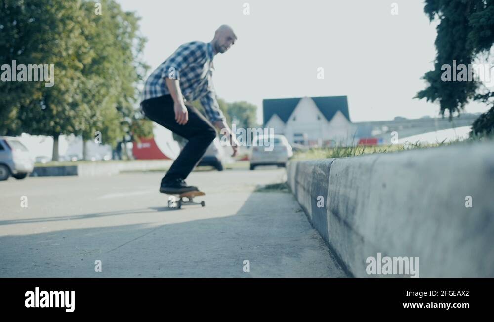 Skateboarder doing a skateboard tail board slide over the rail at the