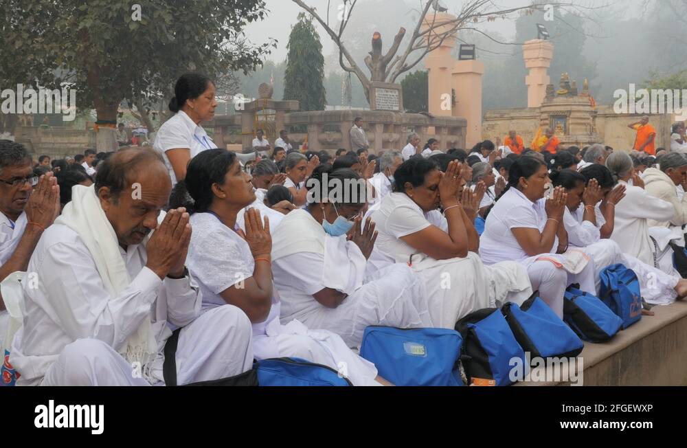 White dressed buddhist pilgrims praying,BodhGaya,Mahabodhi Temple