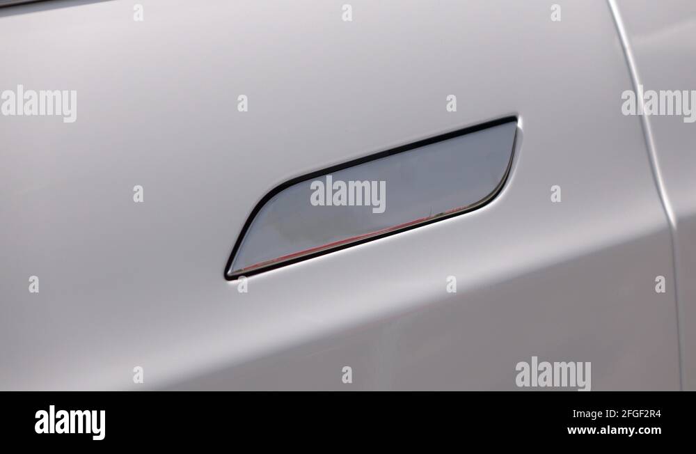 CLOSE UP Tesla ecological electric car door handle coming out of the