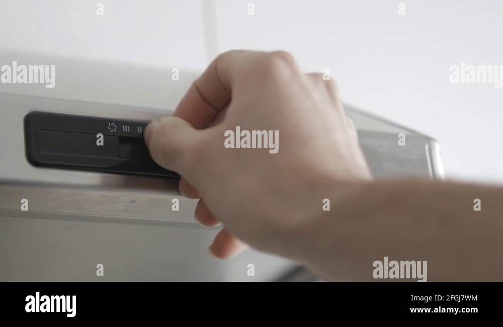 4K Turning on the Range Hood Cooking Ventilation Over an Oven Stock