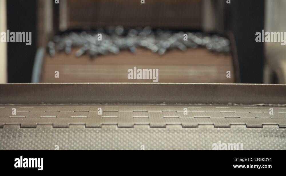 Metal bolts in a conveyor belt Stock Video Footage Alamy