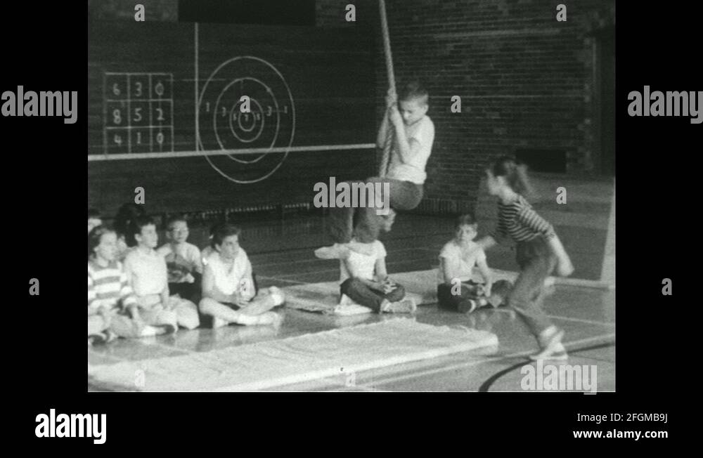 United States, 1961 Boy swings back and forth on rope as girl follows