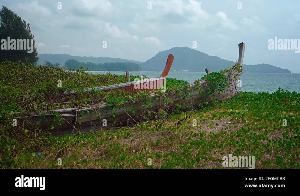 Abandoned Wooden Boats Rotting in the Sand on a Beach in Thailand Stock
