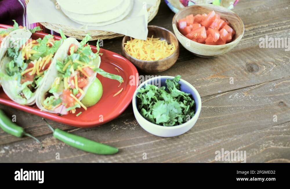 Ground beef tacos with romaine lettuce, diced tomatoes, and shredded