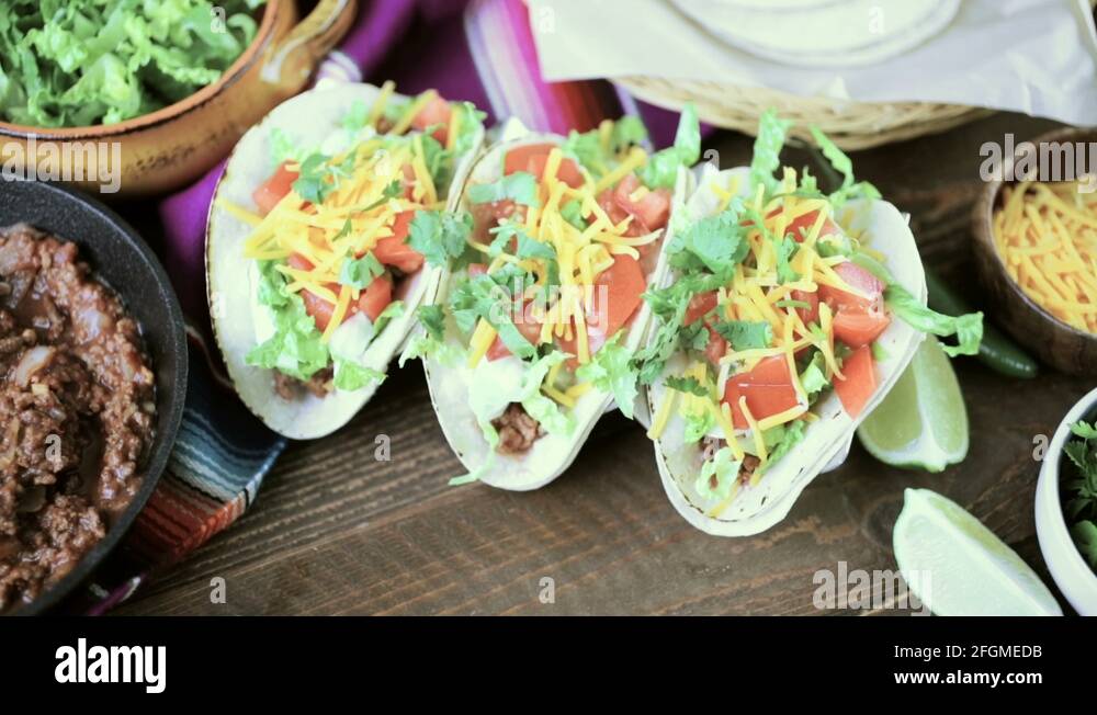 Ground beef tacos with romaine lettuce, diced tomatoes, and shredded
