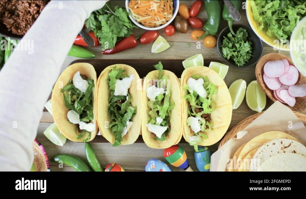 Ground beef tacos with romaine lettuce, diced tomatoes, radishes, and