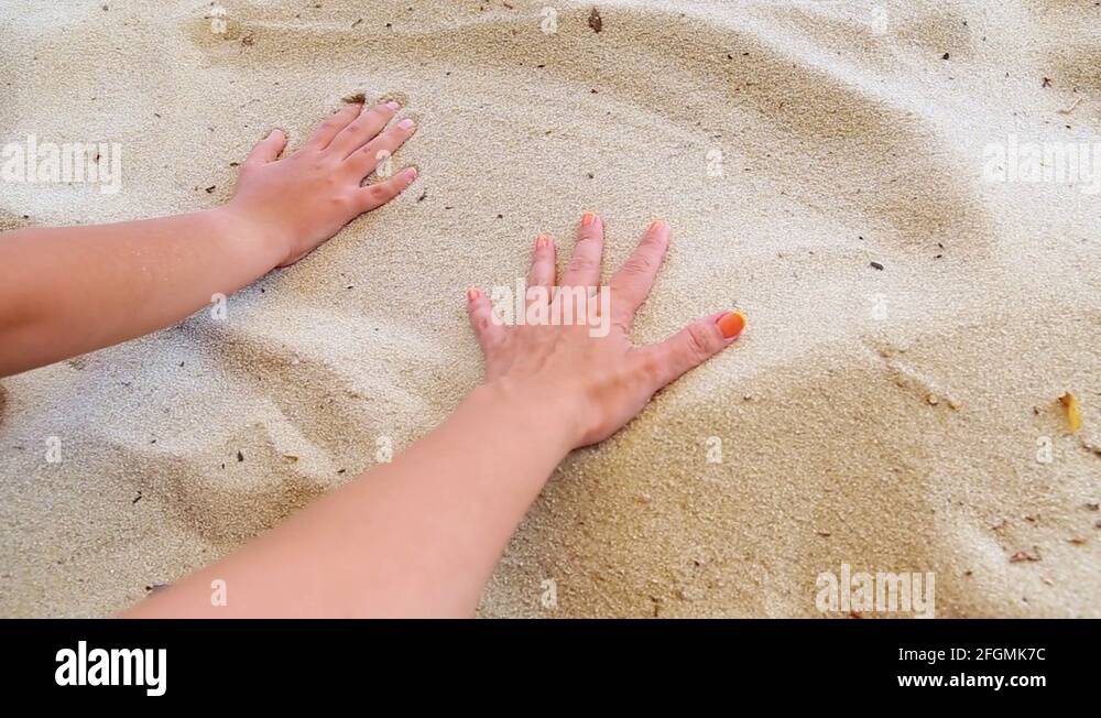 Mother and little son making handprints in sand on river beach Stock ...