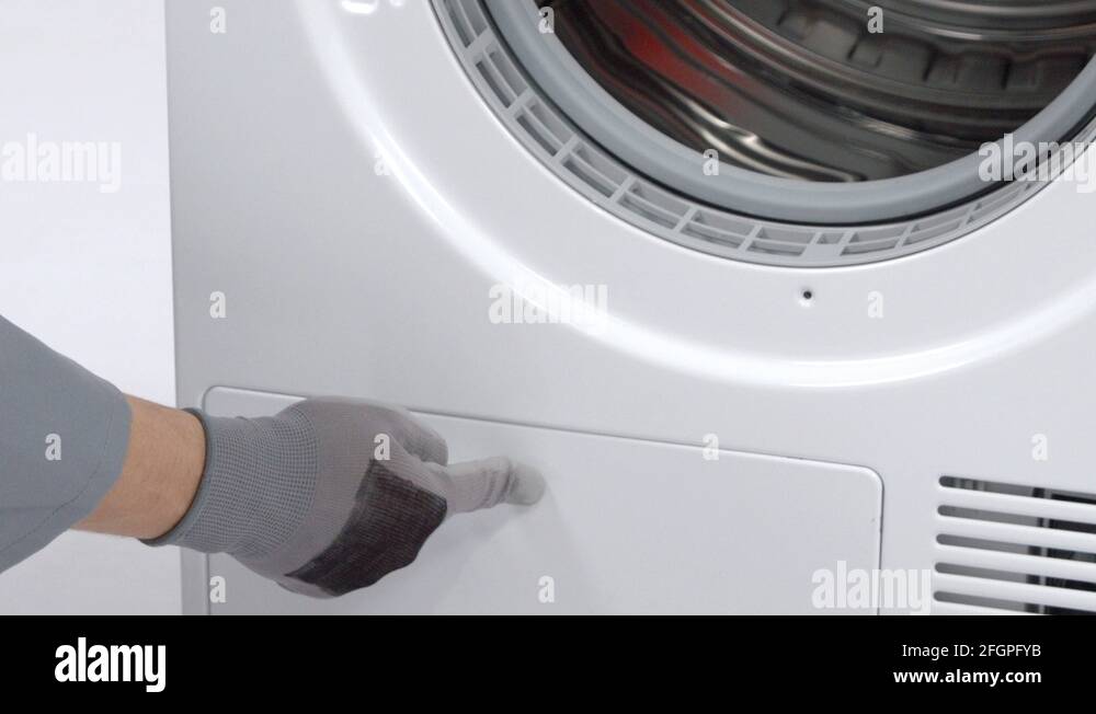 Opening the bottom part of a washing machine and turning the buttons