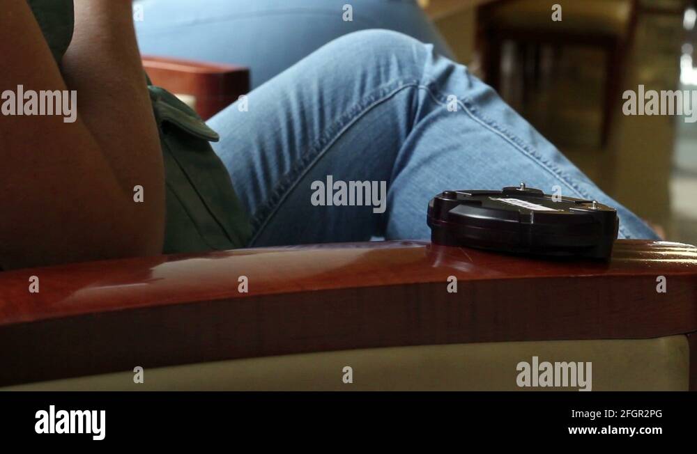 Hospital beeper device sitting on chair in lobby Stock Video Footage