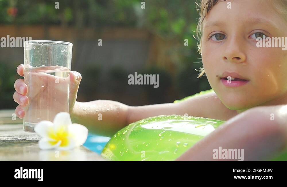 Boy sunbathing in swimming pool Stock Videos & Footage HD and 4K