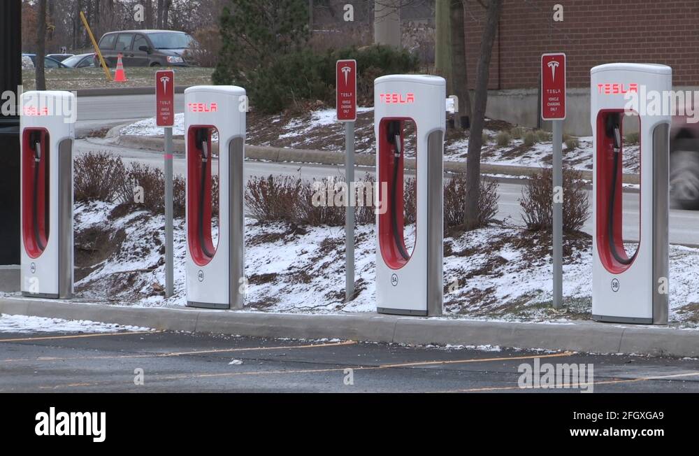 Tesla electric car charging gas station in Barrie Canada Stock Video