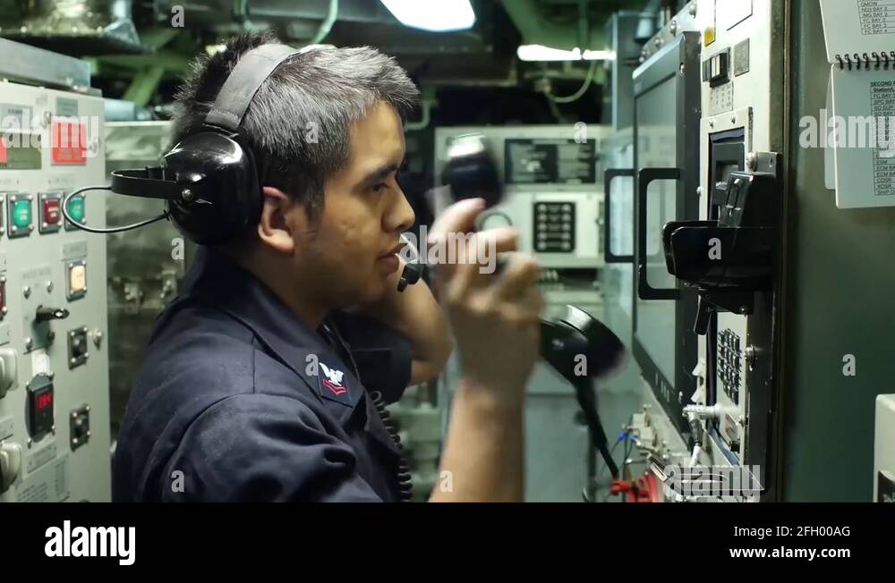 USS Navy Submarine mechanic busy testing control panel and its readings
