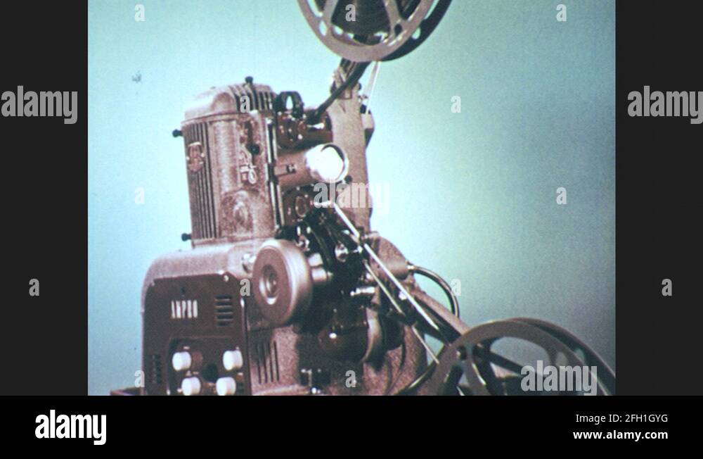 1950s: UNITED STATES: film threaded on projector. Motion picture ...