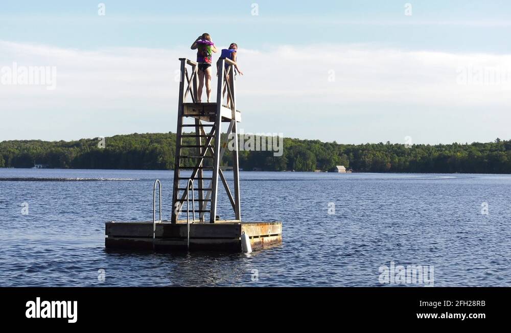 little girl jumps off water tower in lake 4k Stock Video Footage Alamy