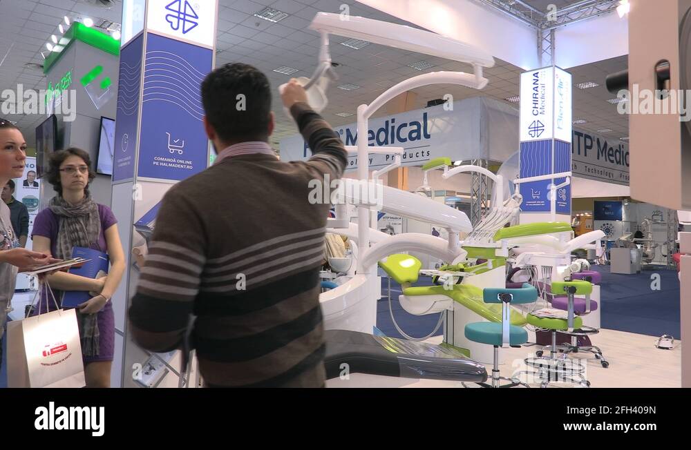 Vendor showing customers a dental chair at dental technologies