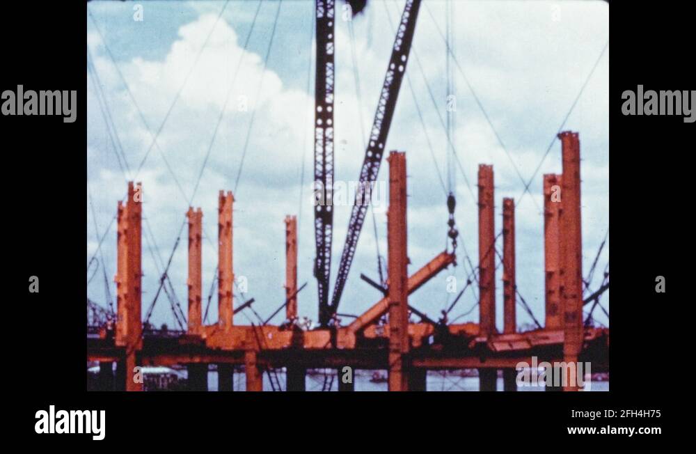 1950s Hook and crane lift steel column. Crane lifts bundle of steel girders Stock Video Footage