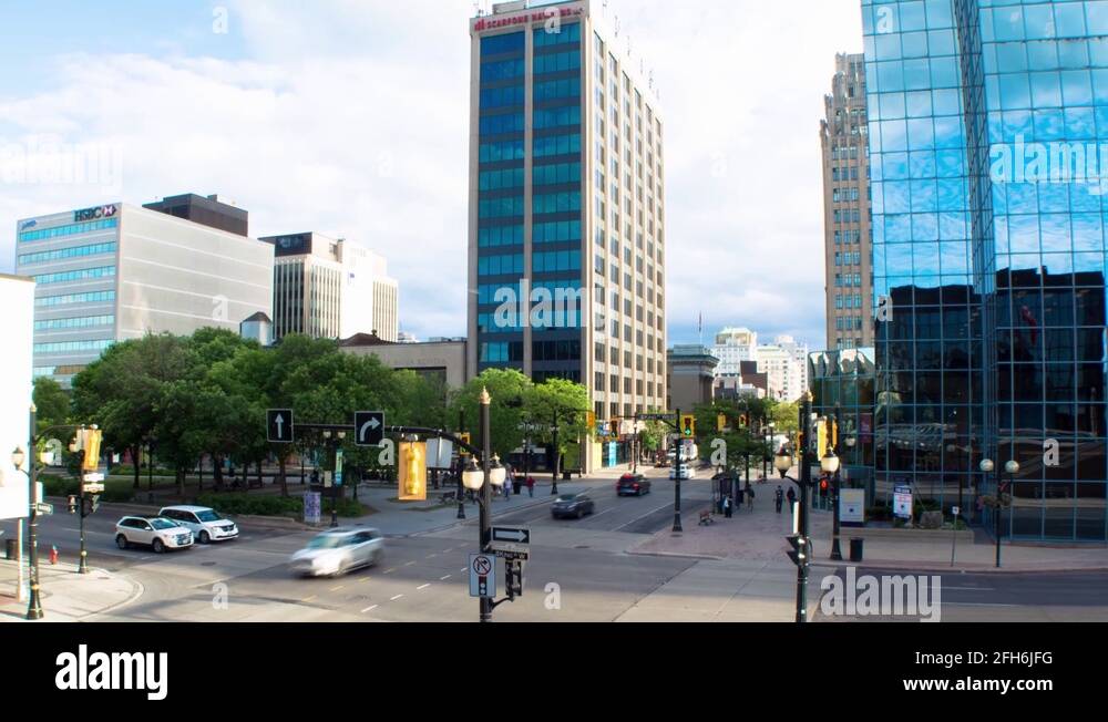 Cars pass by a busy intersection in downtown Hamilton. Buildings