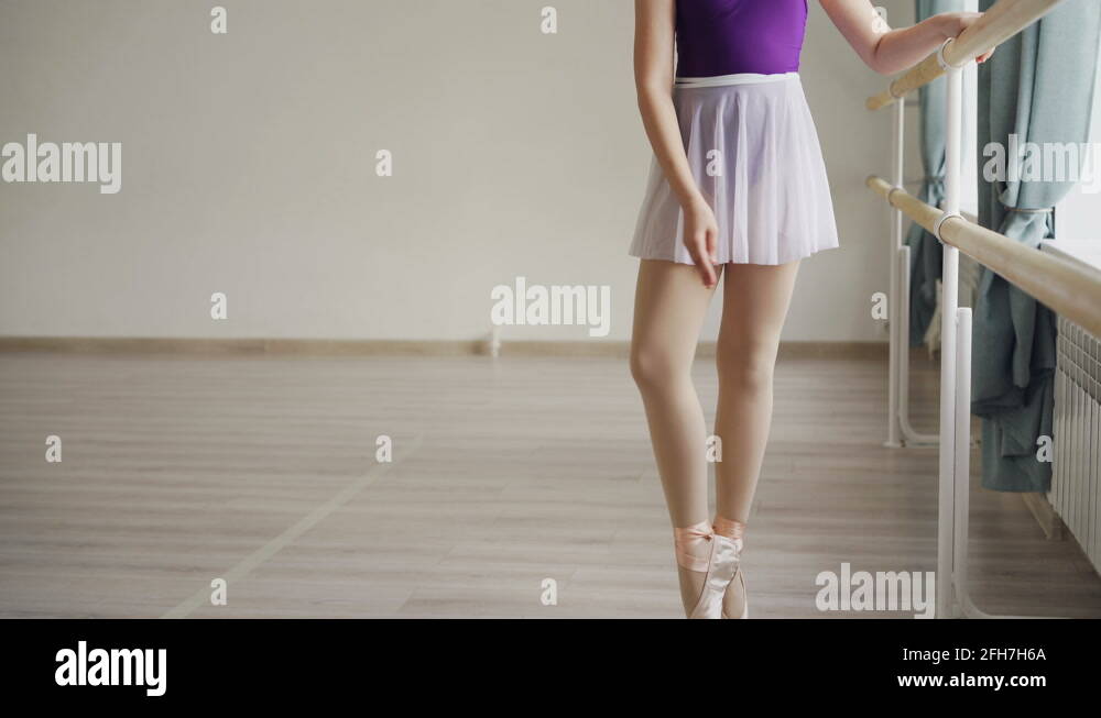 Pretty little girl in bodysuit and tutu is having individual ballet