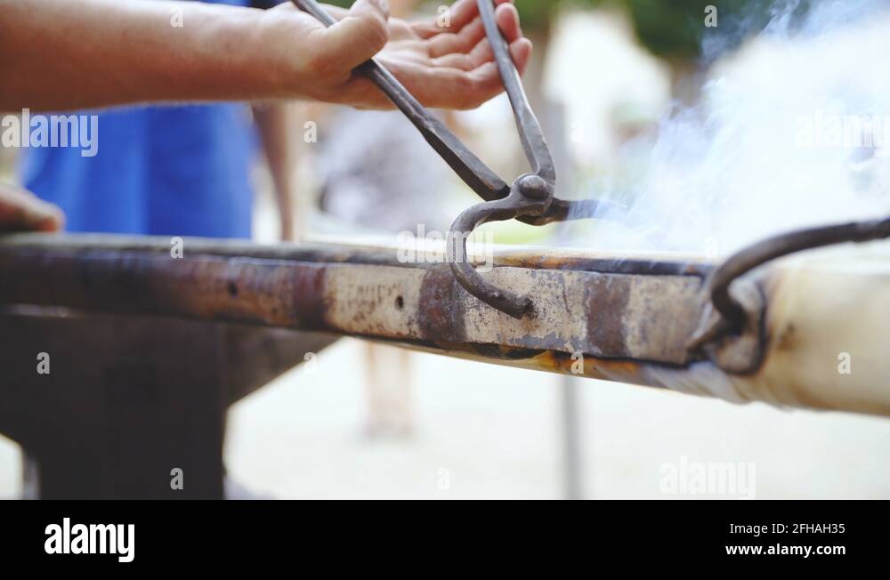 Blacksmith protects carriage splinter bar with hot iron layer closeup 4K Stock Video Footage