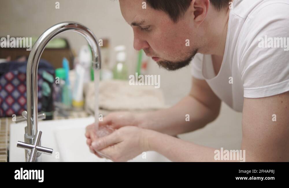 Washing her face in a bathroom sink Stock Videos & Footage HD and 4K