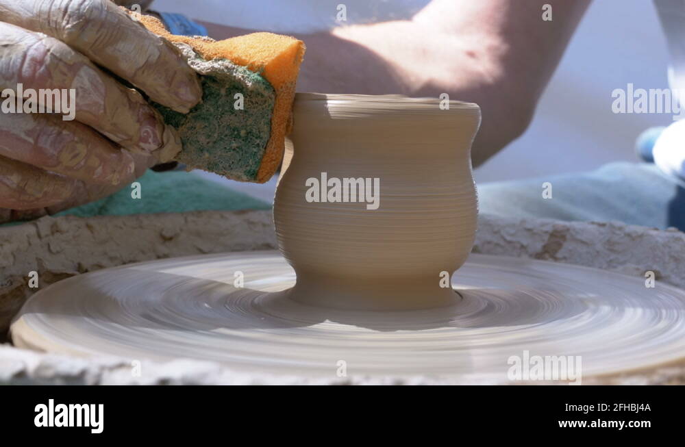 Hands of the Master Potter and Vase of Clay on the Potter's Wheel Stock