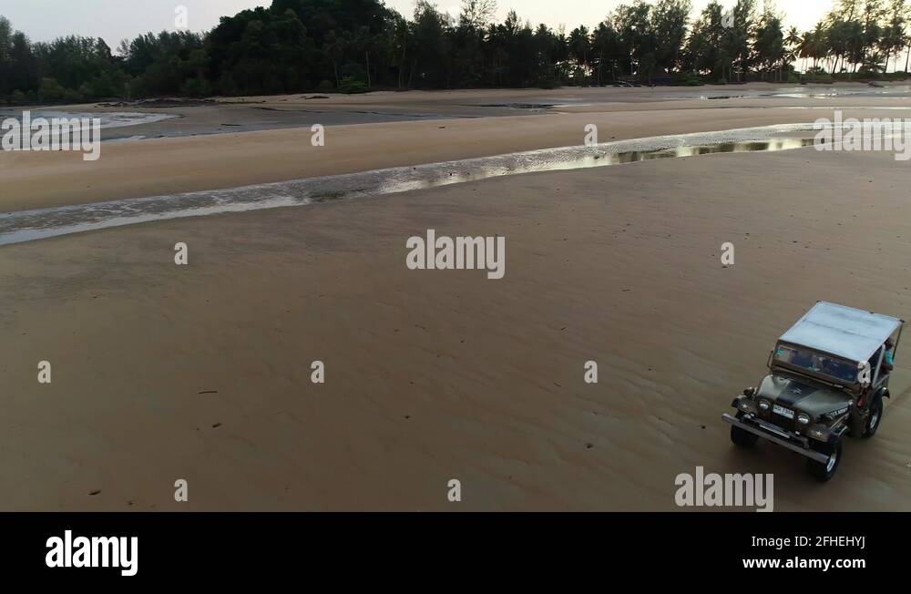 Drone footage of car driving on beach Stock Video Footage Alamy