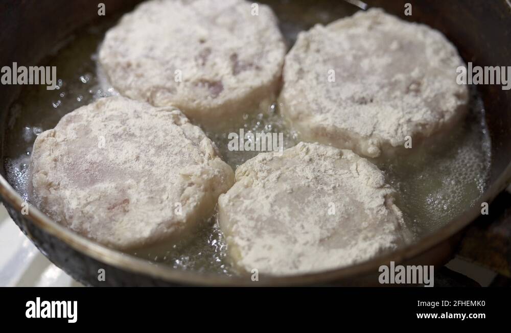 Сooking homemade fried fish burger patty. Frying fish patties with hot