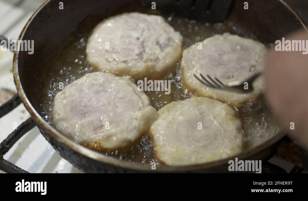 Сooking homemade fried fish burger patty. Frying fish patties with hot