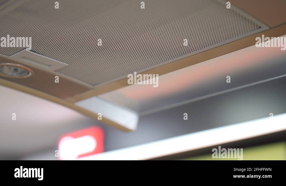Close up of a modern kitchen hood fan in silver chrome above an oven